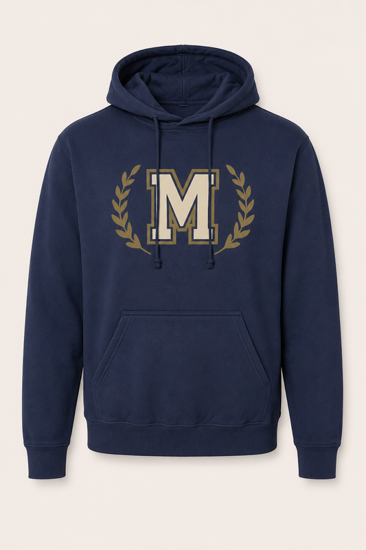 A navy blue pullover hoodie with a large gold and cream letter 'M' inside a laurel wreath on the chest, displayed against a light beige background.